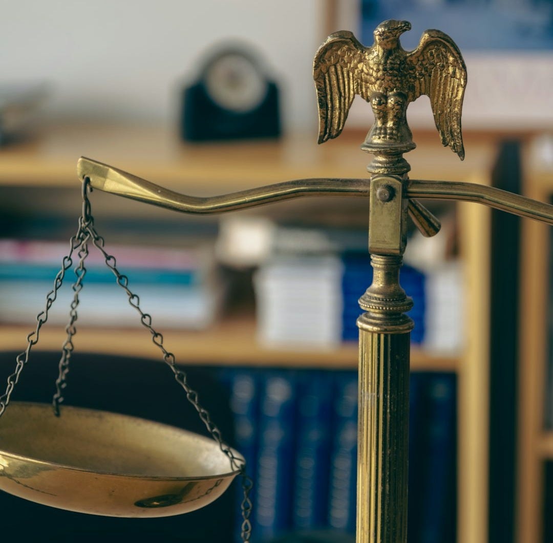 a golden scale with an eagle on top of it a golden scale with an eagle on top of it