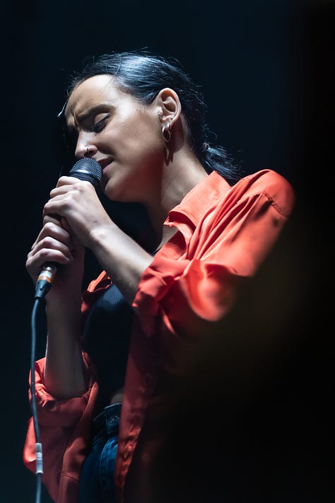 A series of images from Manic Street Creature, where Maimuna plays guitar on stage