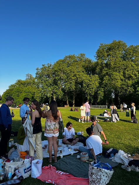two women in front of the O2 arena; a woman in front of Keats House in Hampstead, two women in front of the Royal Opera House in London; the inside of the Royal Opera House in London; tower bridge at night; a picnic in the park