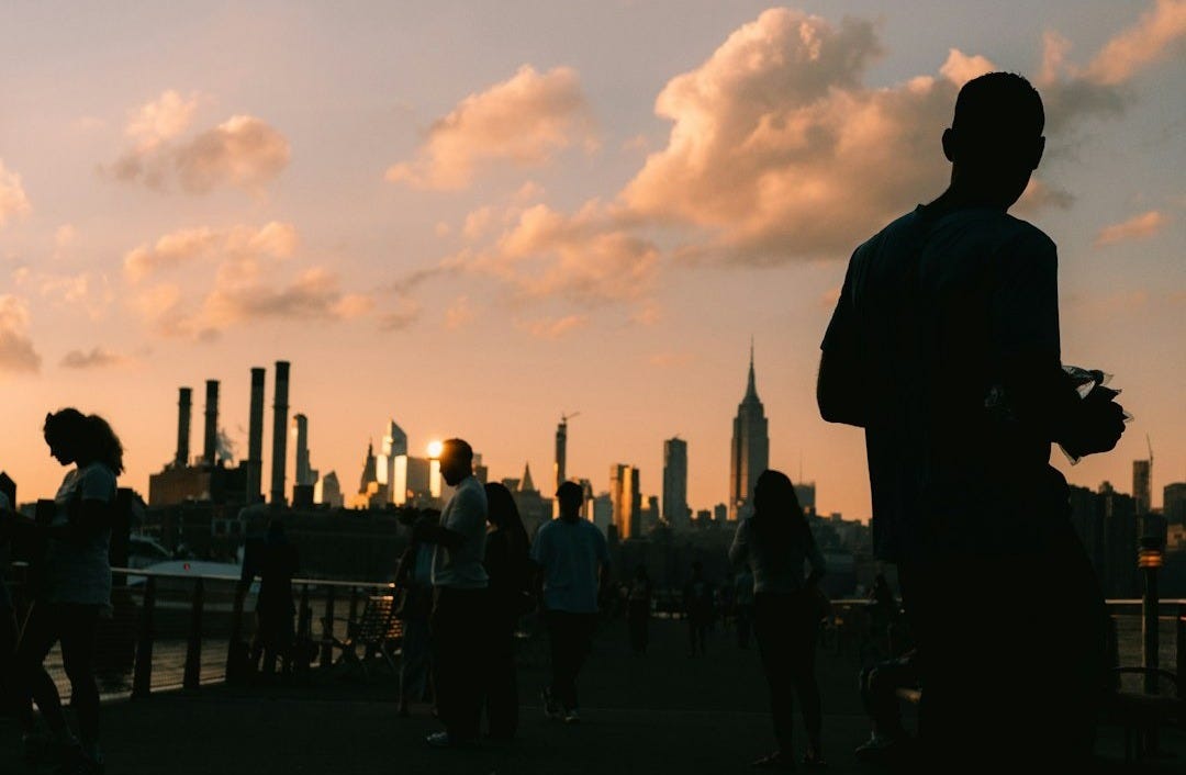 A group of people standing on top of a bridge