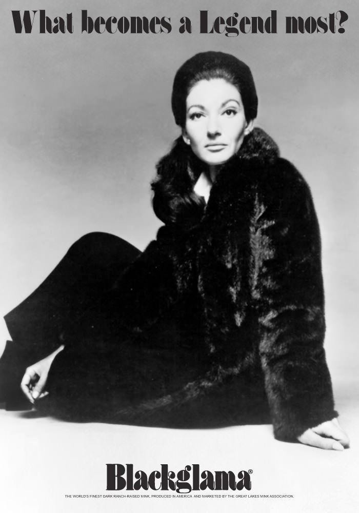 A woman with coiffed, upswept hair sits on the floor while wearing a black mink coat and staring directly into the lens.