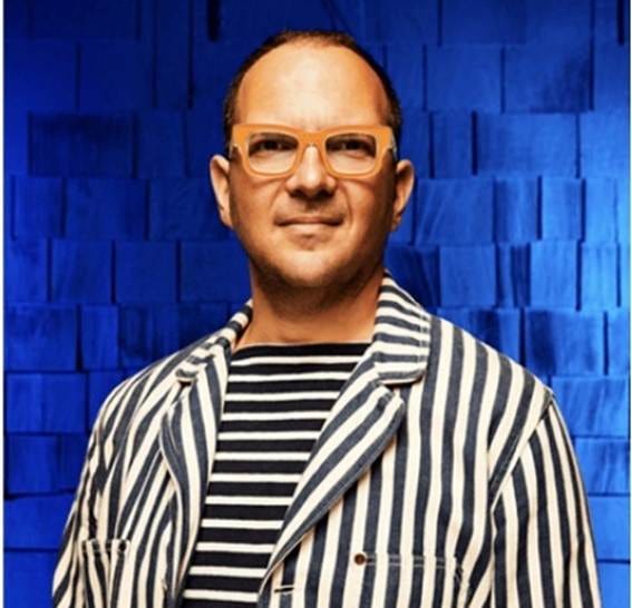 A person in a striped shirt and orange glasses

AI-generated content may be incorrect.