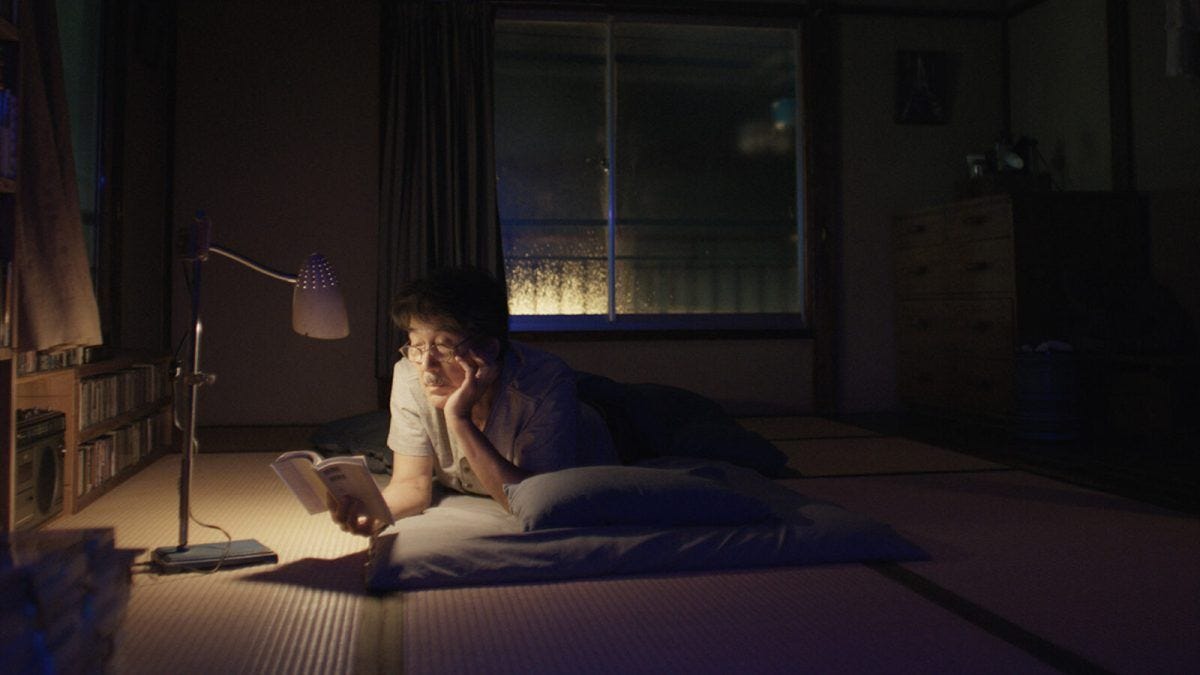 Hirayama, the protagonist of Perfect Day, reads a book in bed at night.