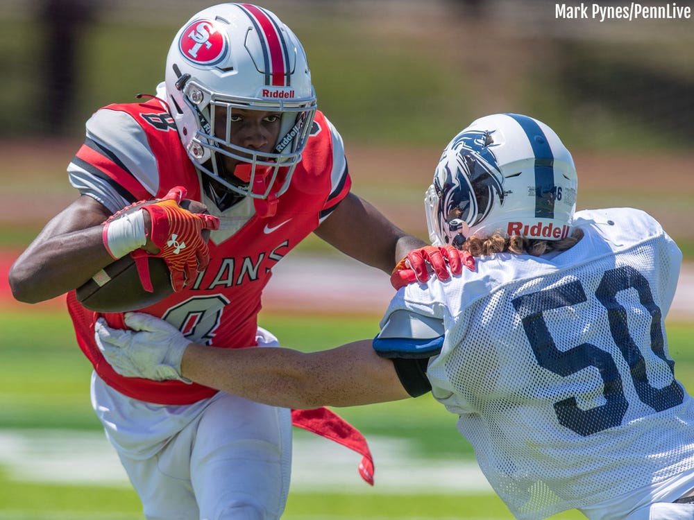 Lex Cyrus breaks past Marc-Anthony Scaringi in a scrimmage between Camp Hill and Susquehanna Township before the 2023 season. (Mark Pynes/PennLive)