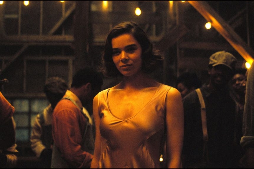 A beautiful young woman wearing a silk dress, standing in a dimly lit room