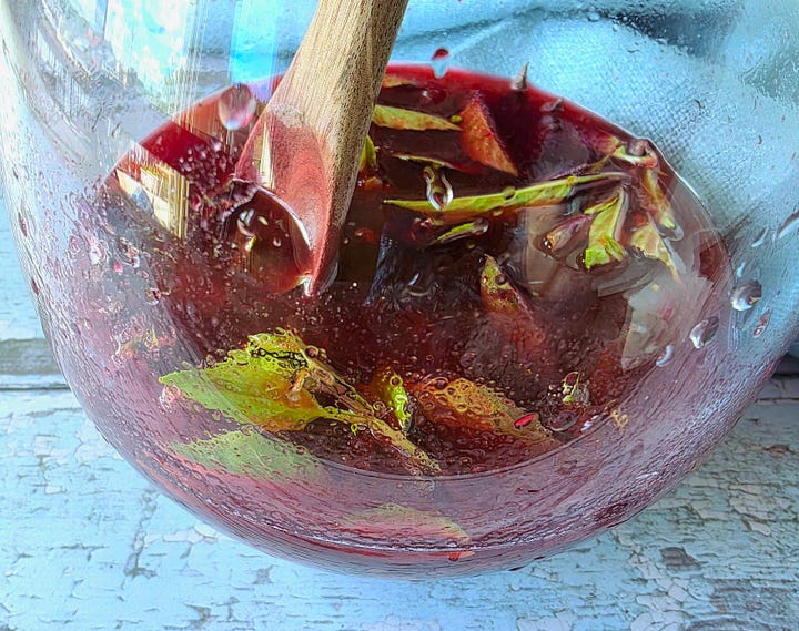 muddling the aromatics, then adding and stirring the liquids for the drink base