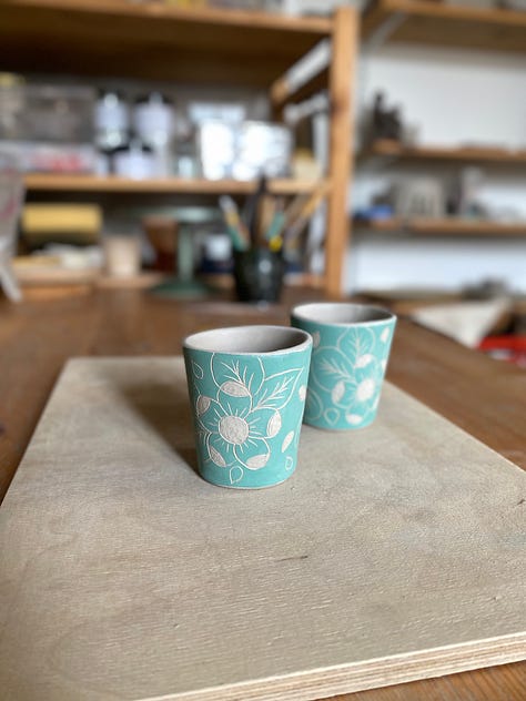unfired clay beakers, tray, mugs and plates