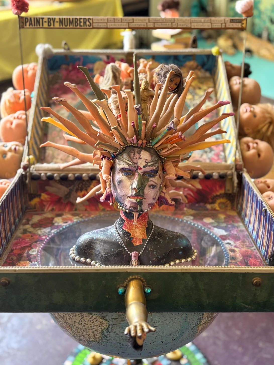 found-object assemblage sculpture made with doll parts