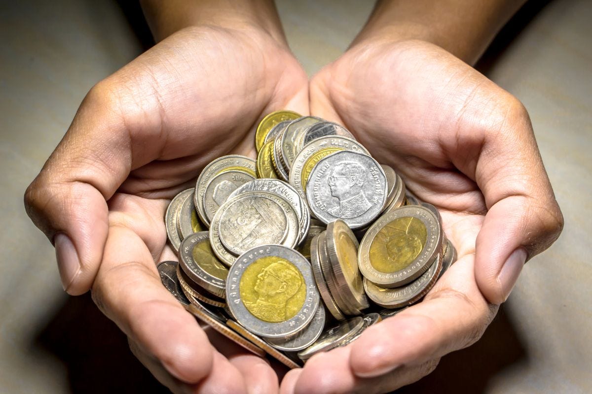 Hands holding coins