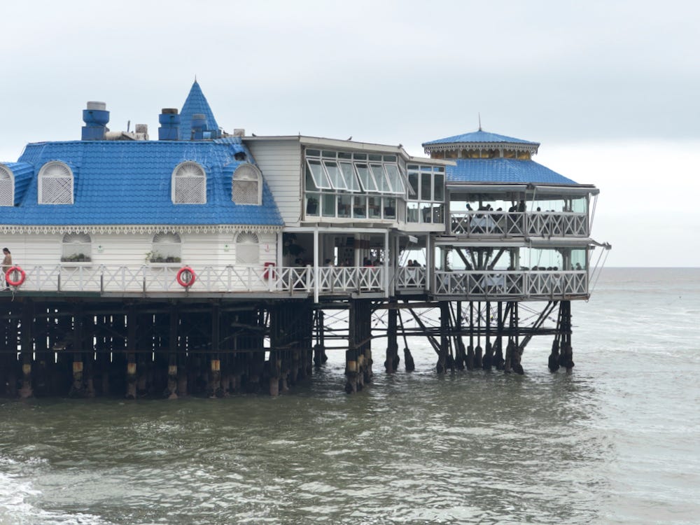 The iconic Victorian building perched above the Pacific ocean that houses La Rosa Nautica