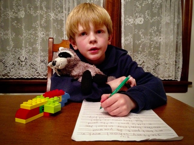 A photo of a young boy practicing writing.