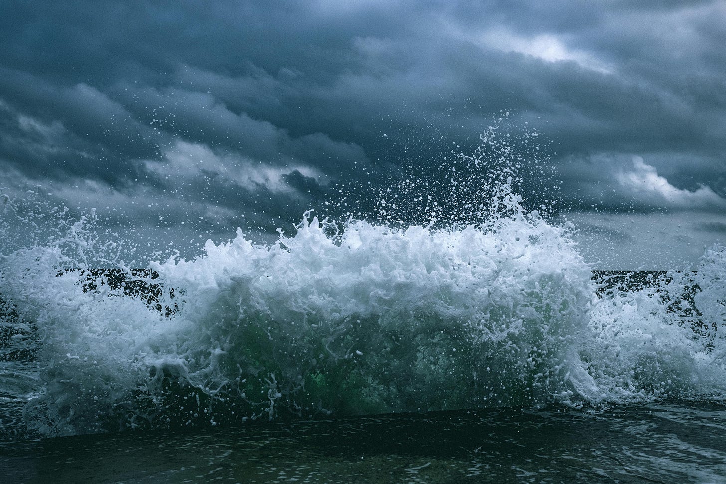 photo of rough waves against a dark sky photo of rough waves against a dark sky