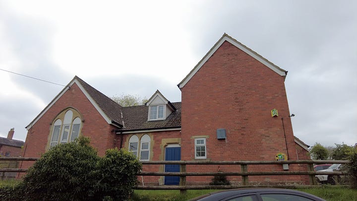 A thatched cottage painted white in the village of Rowde. The village hall was once the reading room.