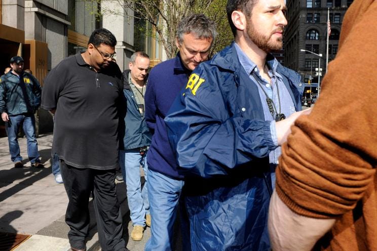 Vadim Trincher (seen in a blue sweater and light blue jeans) is arrested Vadim Trincher (seen in a blue sweater and light blue jeans) is arrested