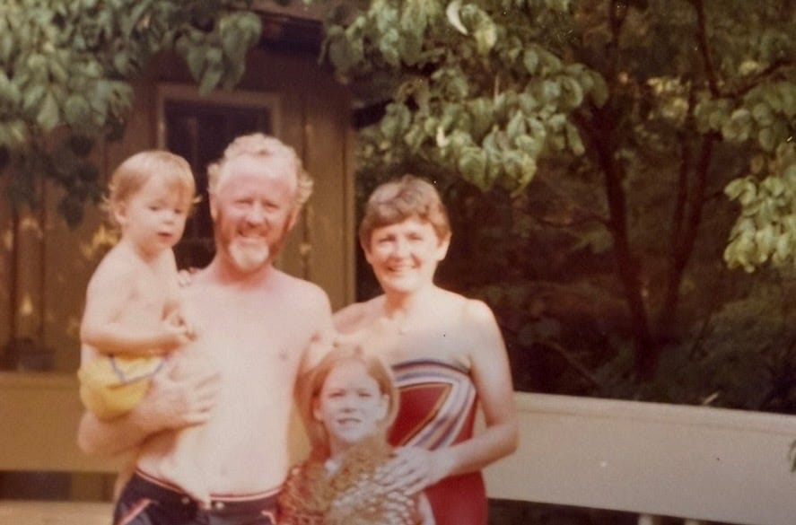 Mother, father, boy and girl posing outside