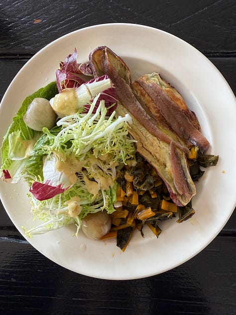 A combination of roast vegetables, tinned fish, greens, eggs, tortillas and sauce