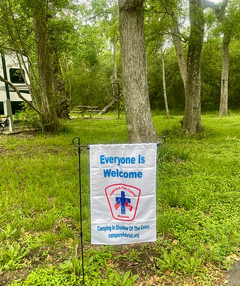 Photos of our site with my writing setup, Paddy's catio, our C4C banner and my stretching video.
