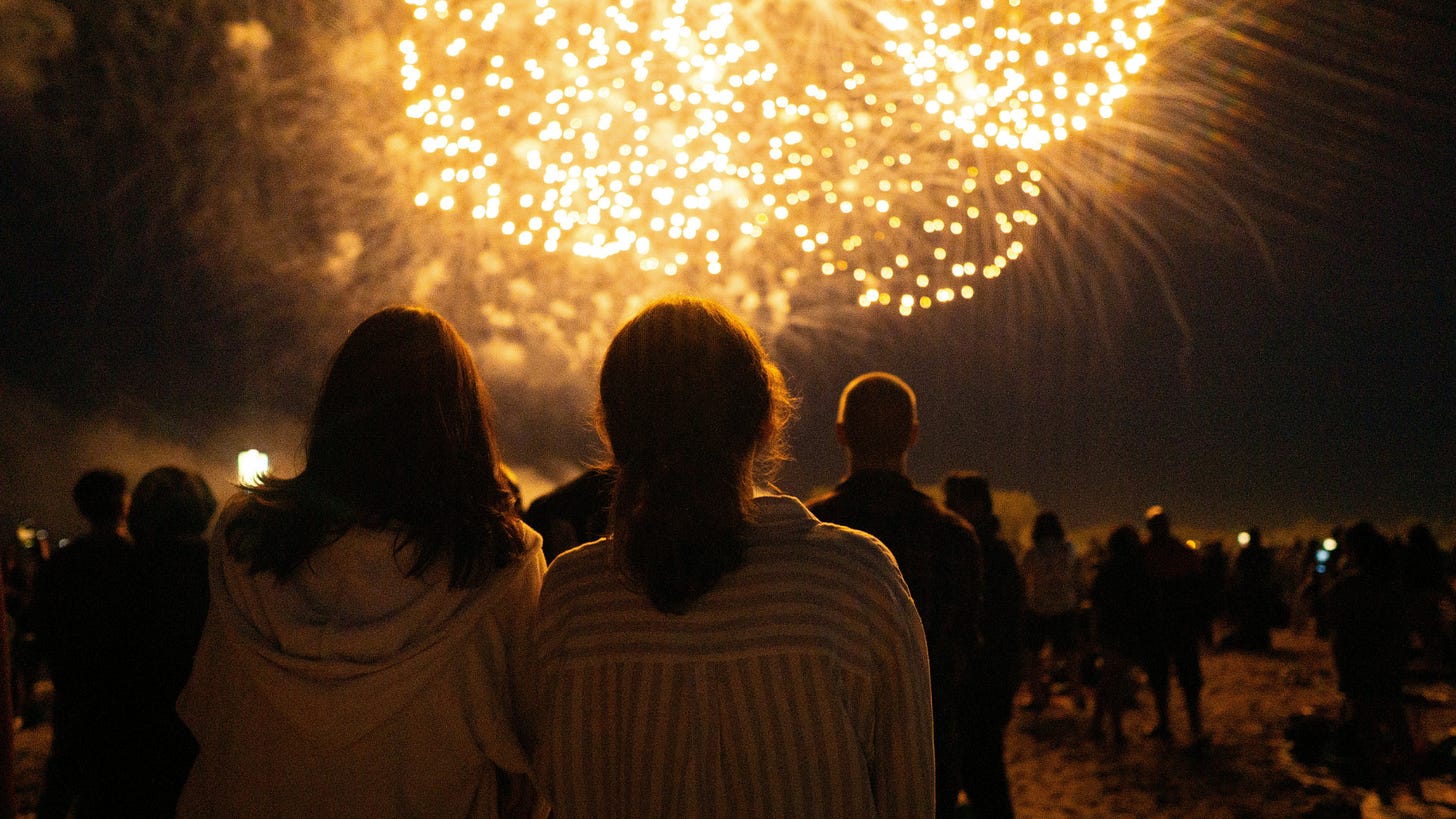 two women watching a 4th of July fireworks display two women watching a 4th of July fireworks display