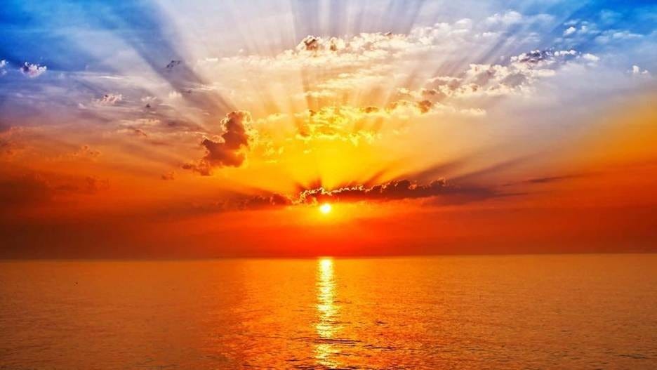 Download Sunrise illuminating a tranquil lake surrounded by trees ...
