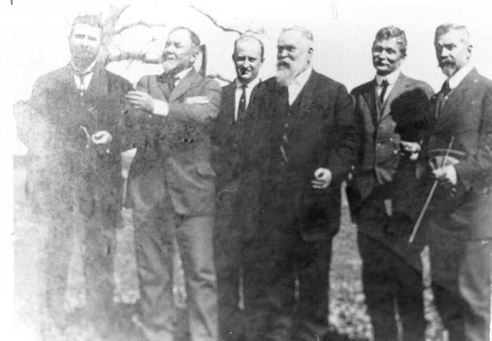 A group of men standing together

AI-generated content may be incorrect.