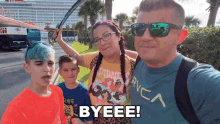 a family taking a selfie with the words byeee written on the bottom