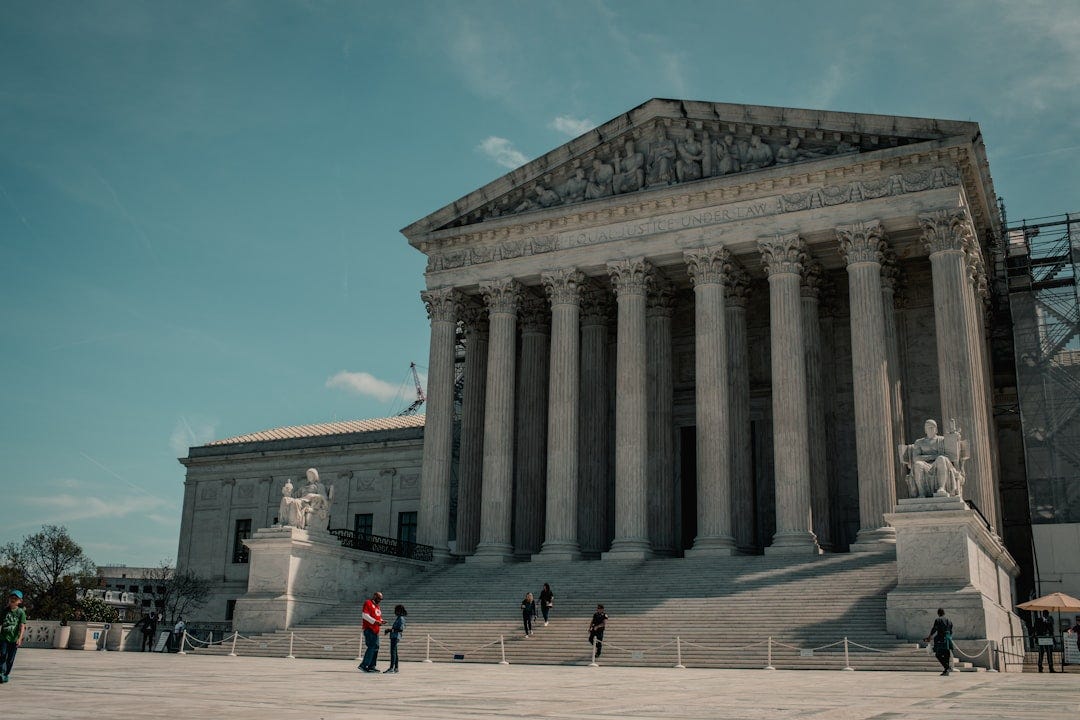 a group of people standing in front of a building a group of people standing in front of a building