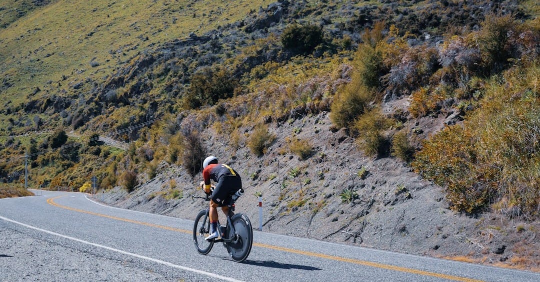 A man riding a bike down a curvy road