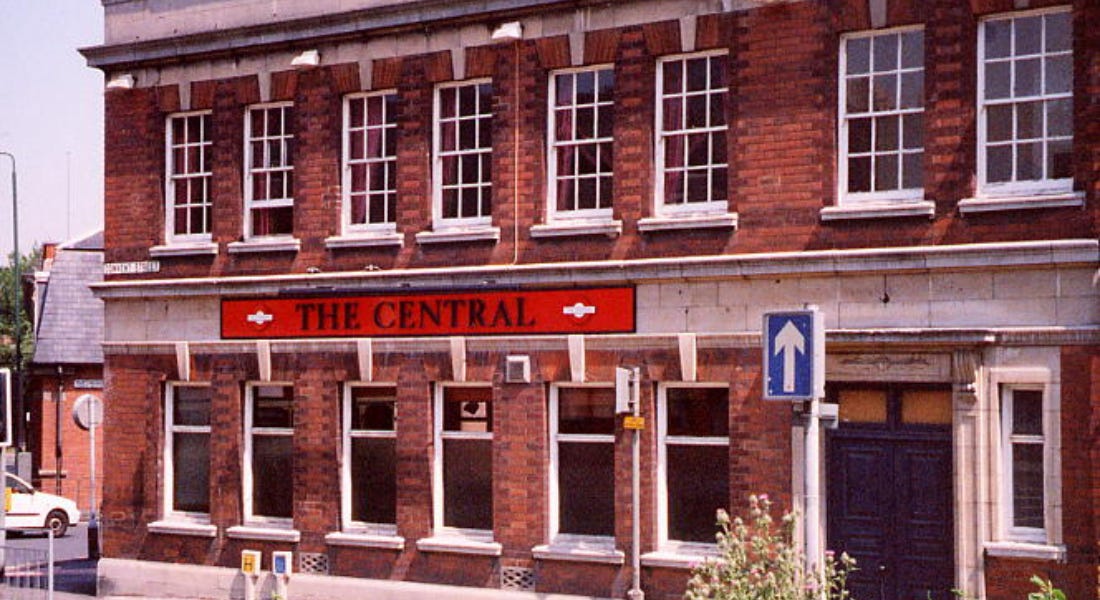 A large brick building with a red sign that says 'The Central' on it
