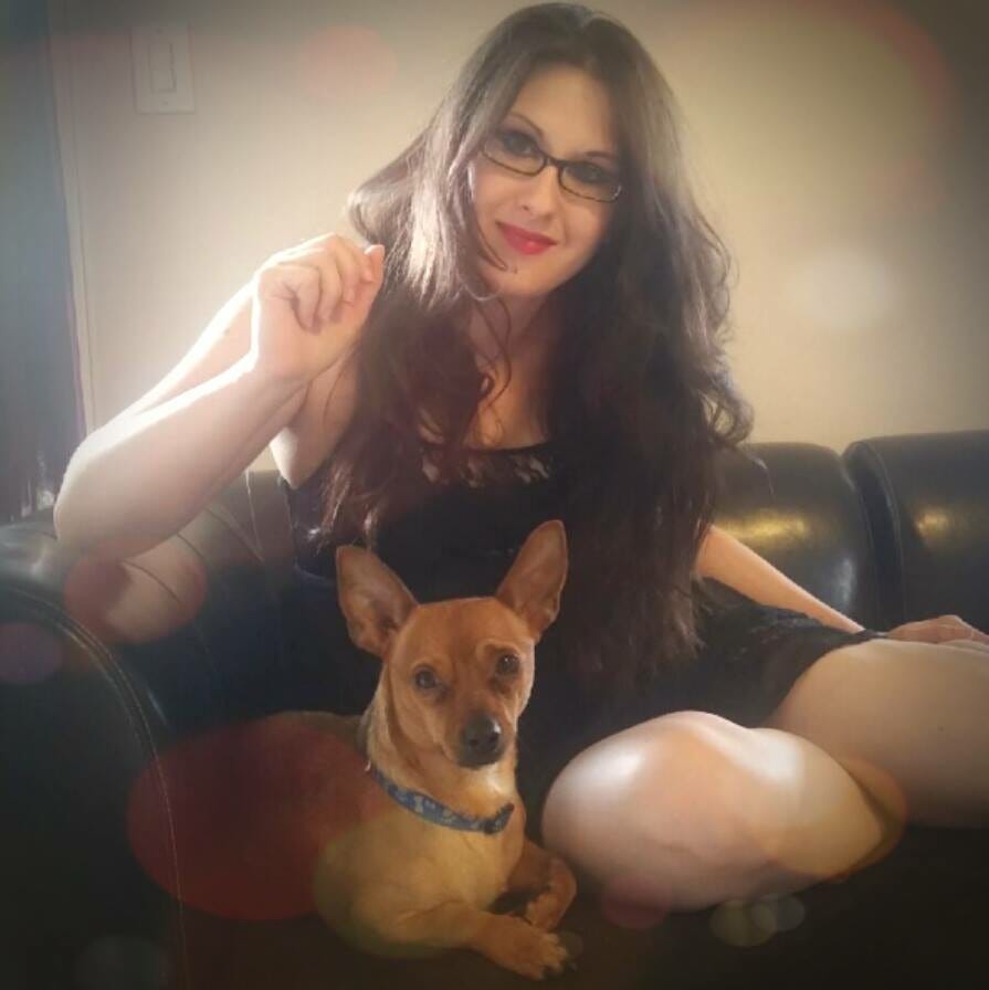 Photo of Lyric, when they did not yet know they were Autistic - they have long dark hair, that is wavy, they are sickly pale from staying indoors too much, and wear a black dress and red lip-stick. They sit in a brown sofa with Copper the Chiweenie. Photo of Lyric, when they did not yet know they were Autistic - they have long dark hair, that is wavy, they are sickly pale from staying indoors too much, and wear a black dress and red lip-stick. They sit in a brown sofa with Copper the Chiweenie.