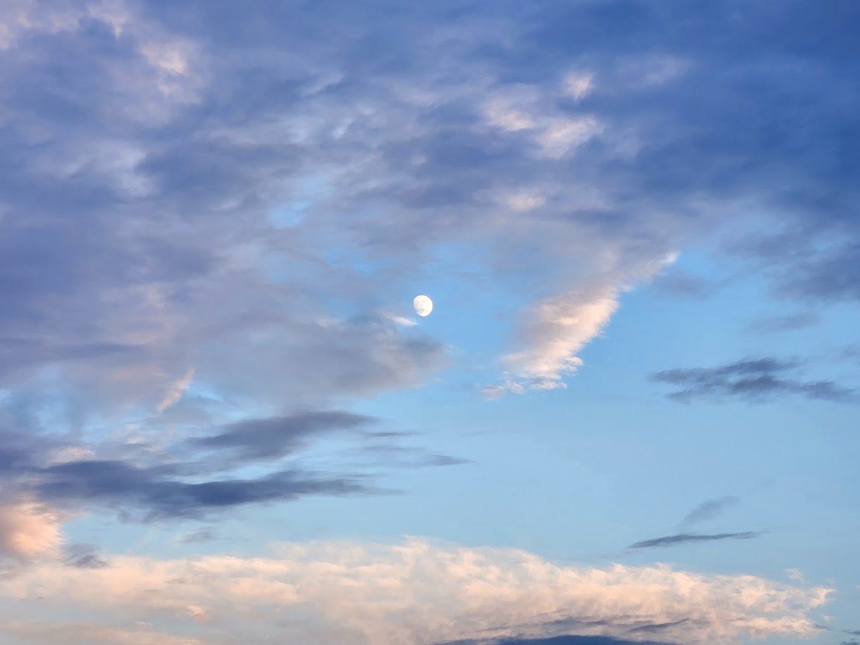 Picture of the waxing moon among dynamic clouds.