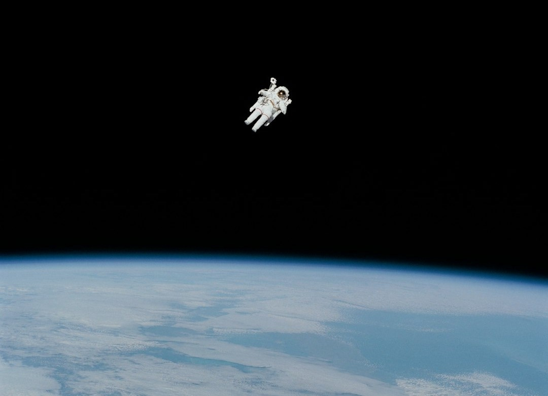 astronaut in spacesuit floating in space