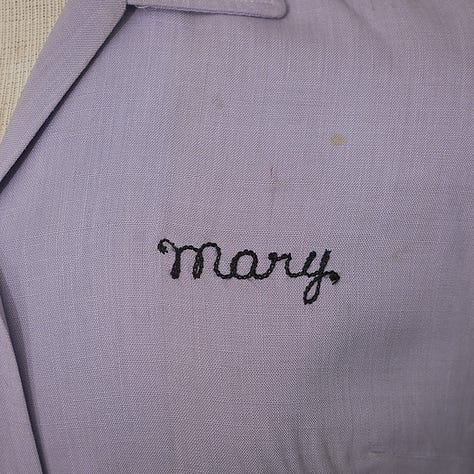 Purple bowling shirt with black embroidery showing "Mary" and "Rossi