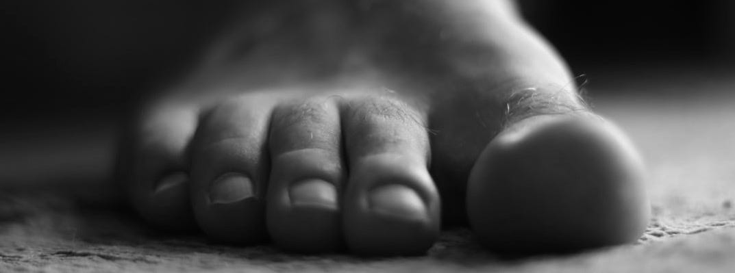 a close up of a person's bare foot on the floor