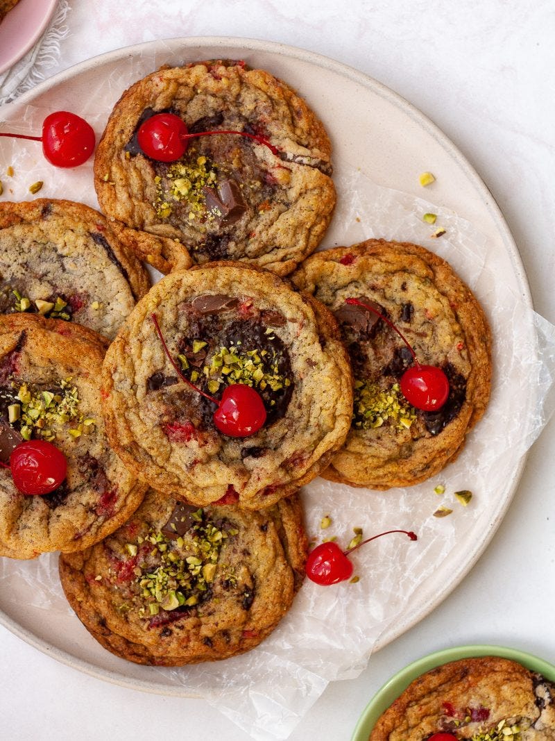 a pile of spumoni cookies sit on a light pink plate on a white background