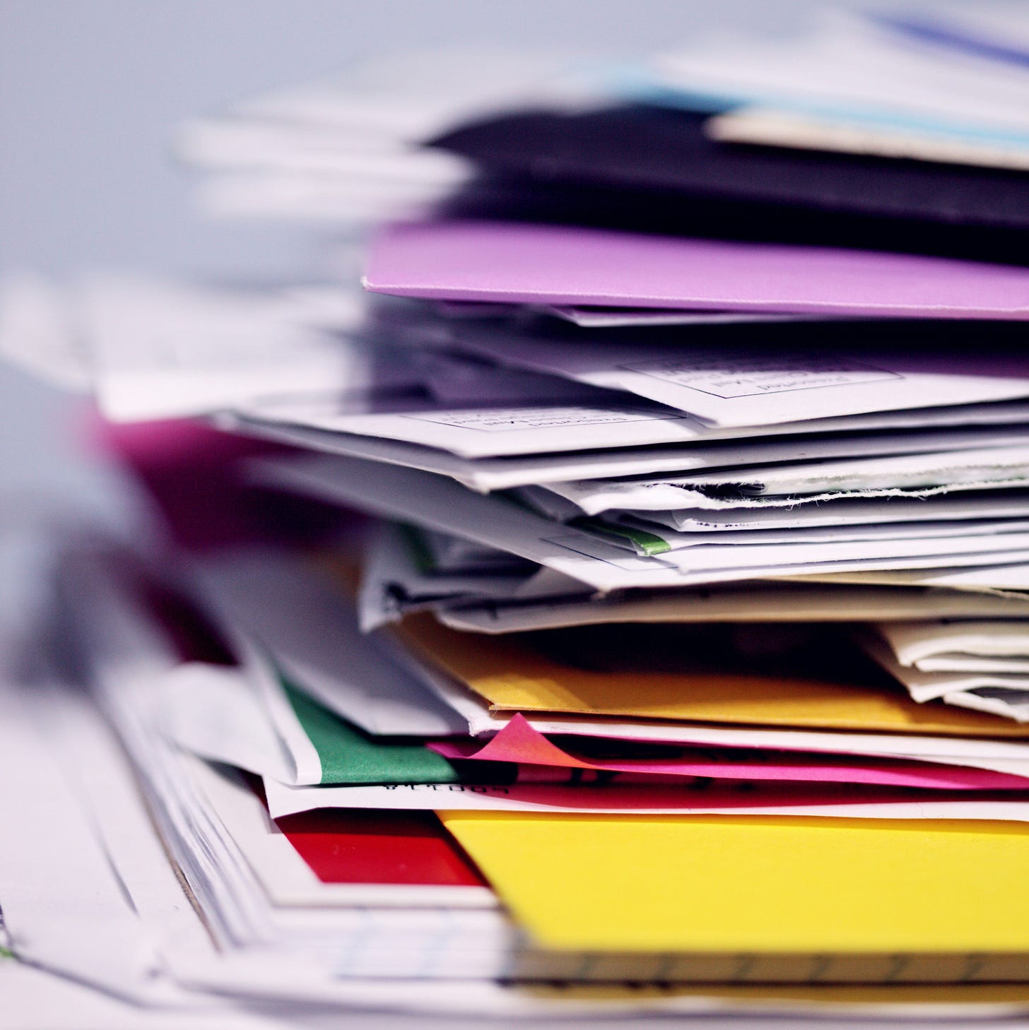 photo is of a stack of untidy papers and folders photo is of a stack of untidy papers and folders