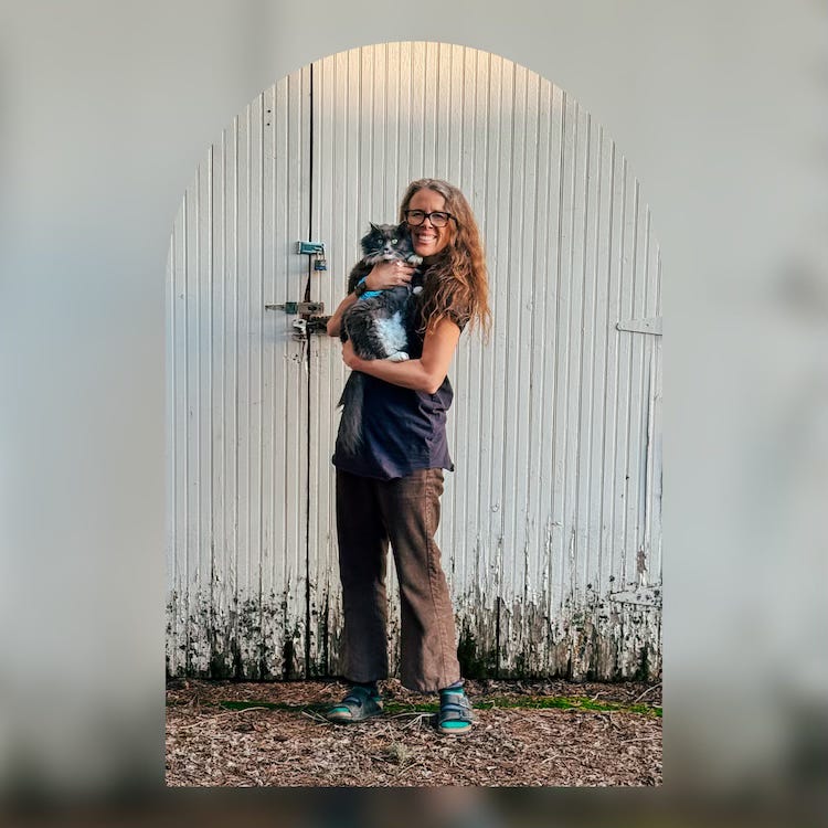 Cheyenne with a Grey and White Cat named Luna outside against an old wooden gargage Cheyenne with a Grey and White Cat named Luna outside against an old wooden gargage