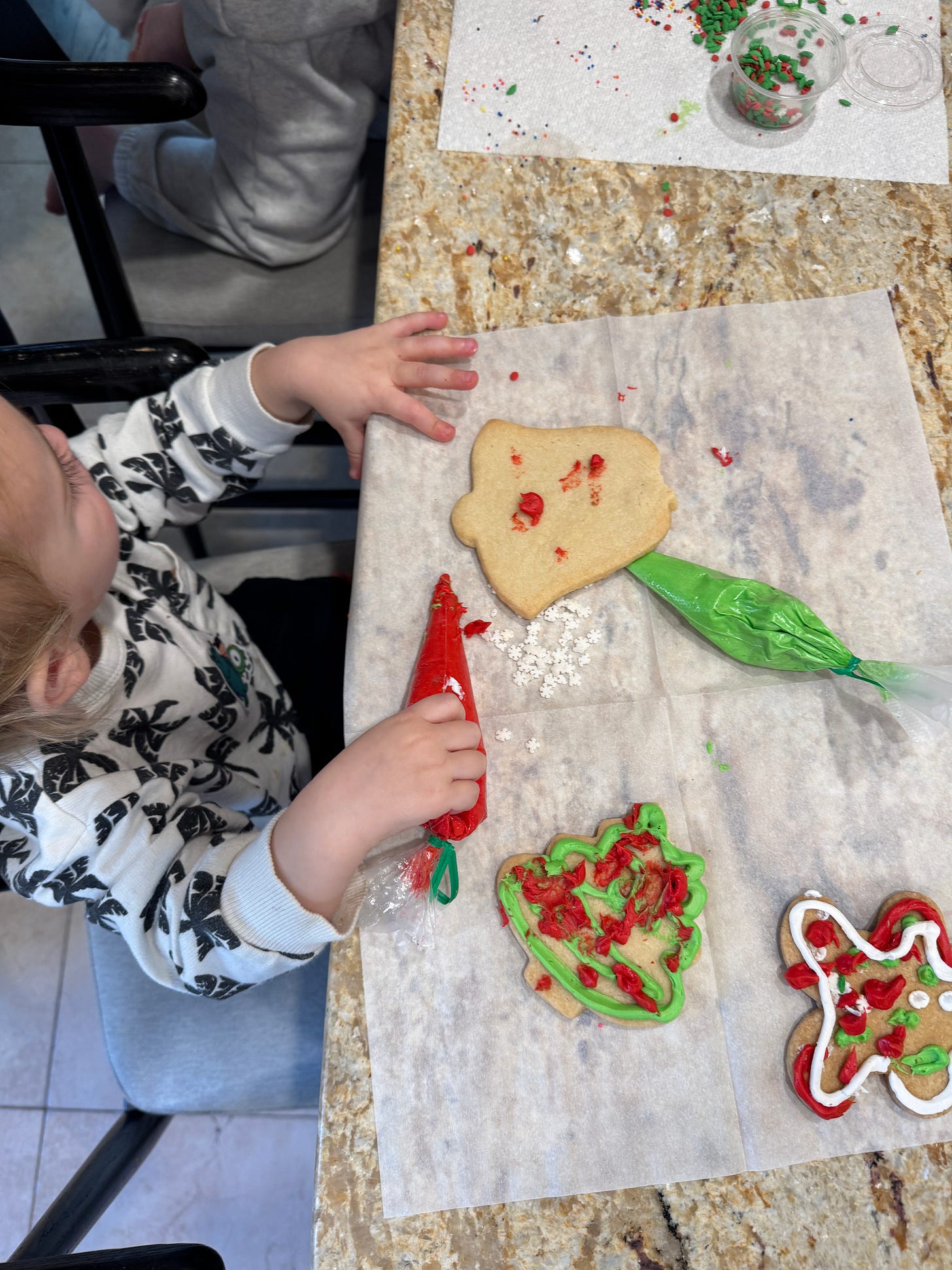 Micah's son frosting Christmas cookies Micah's son frosting Christmas cookies