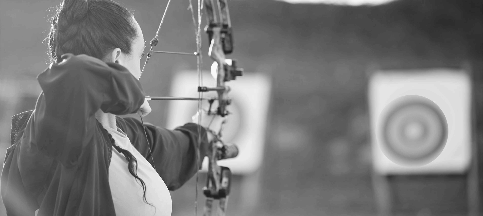 Archer shooting at a moving target representing writing goals.