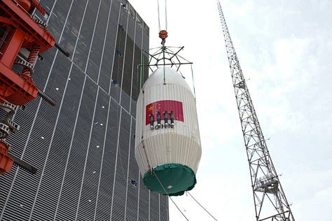 Hardware for the Long March 4C being prepared for launch and being hoisted atop of the vehicle.