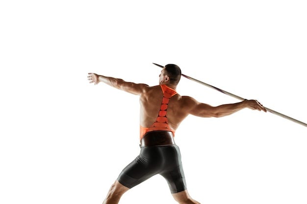 Male athlete practicing in throwing javelin on white studio.