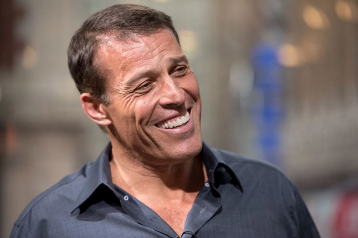 A smiling Tony Robbins in a dark shirt, speaking at an event. Robbins is a world-renowned motivational speaker and entrepreneur known for monetizing personal development. A smiling Tony Robbins in a dark shirt, speaking at an event. Robbins is a world-renowned motivational speaker and entrepreneur known for monetizing personal development.