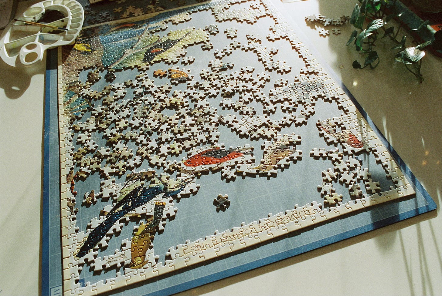 Half-finished jigsaw puzzle in the sunlight on a table