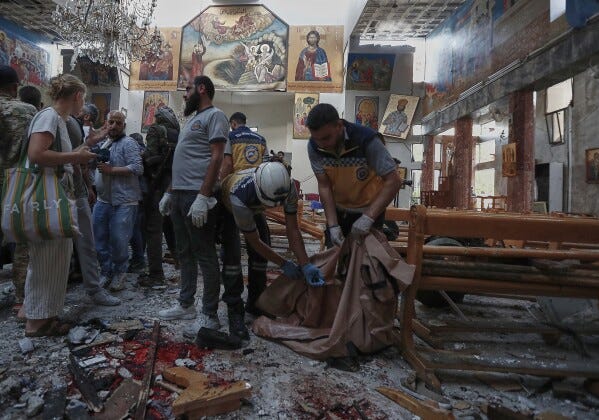 Syrian Civil Defence workers remove body remains inside Mar Elias church where a suicide bomber detonated himself in Dweil'a in the outskirts of Damascus, Syria, Sunday June 22, 2025. (AP Photo/Omar Sanadiki)