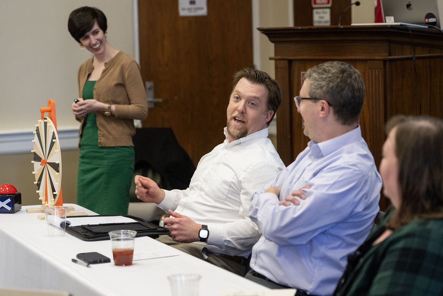 Josh Eyler speaking on the event panel while other CETL staff laugh in the background
