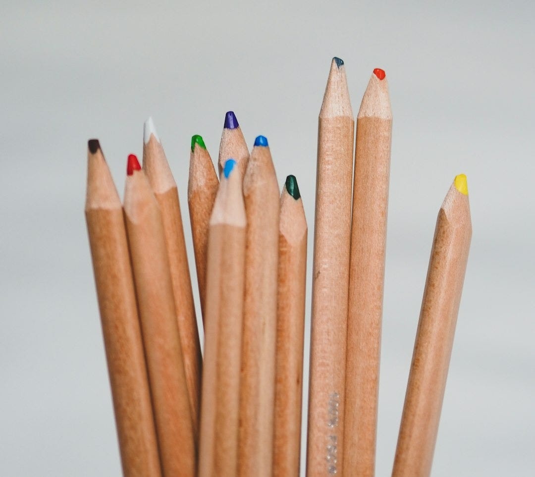 blue and brown pencils on white surface