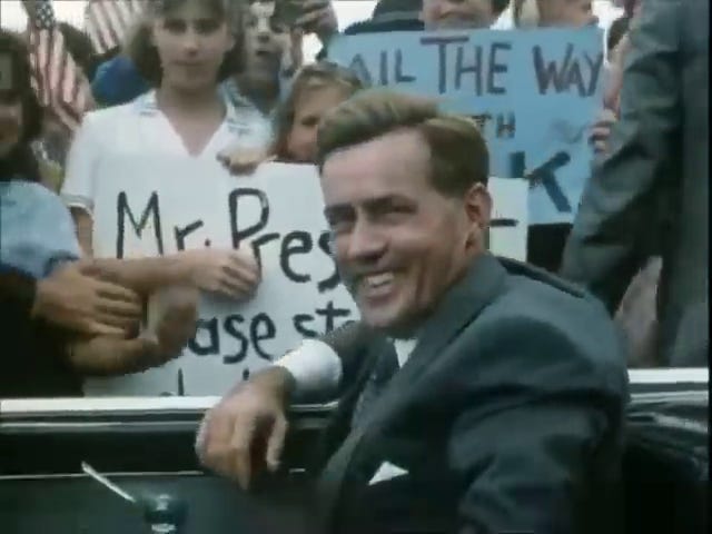 JFK in the motorcade, Jackie in the motorcade, cars in the motorcade, JFK shakes nuns' hands.