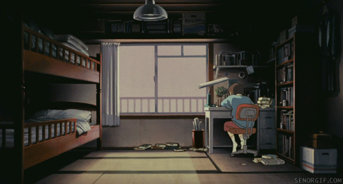 A girl climbs down her desk and lies on the ground.