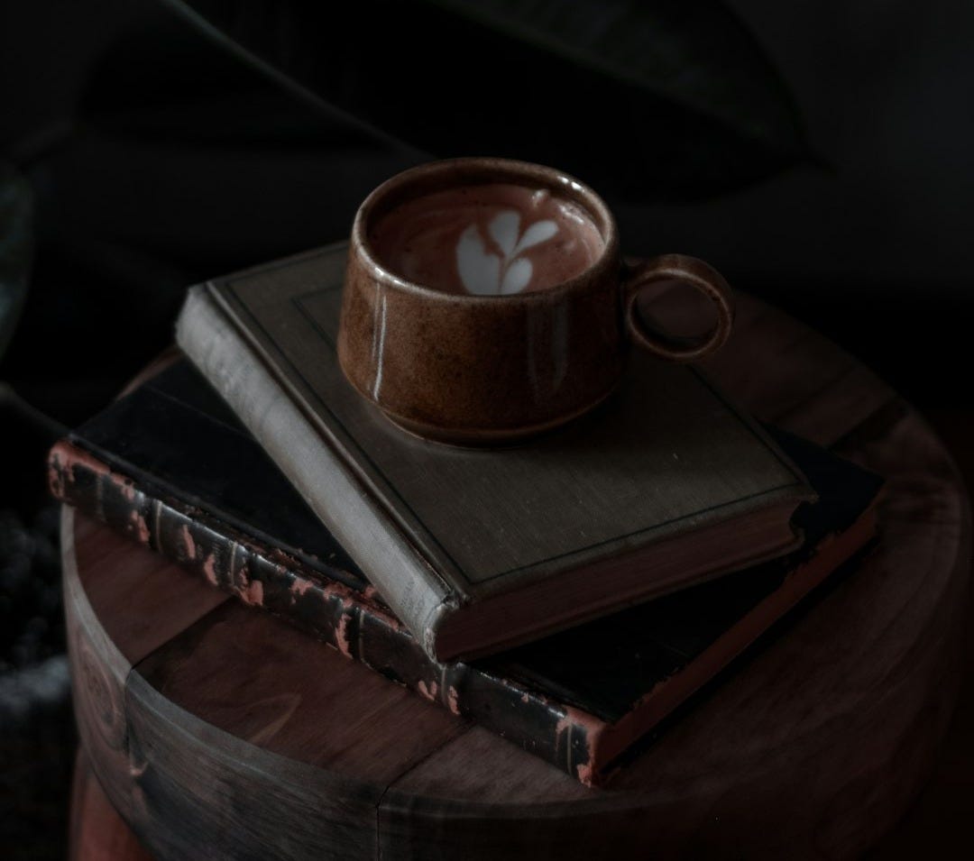 brown ceramic mug on book