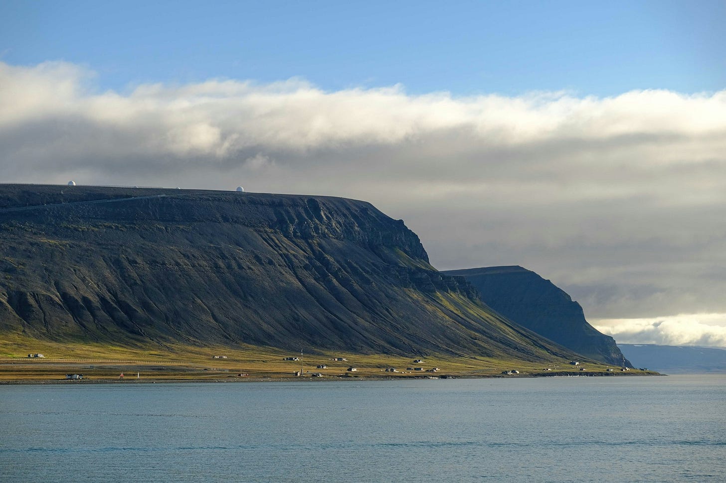 a body of water with a mountain in the background