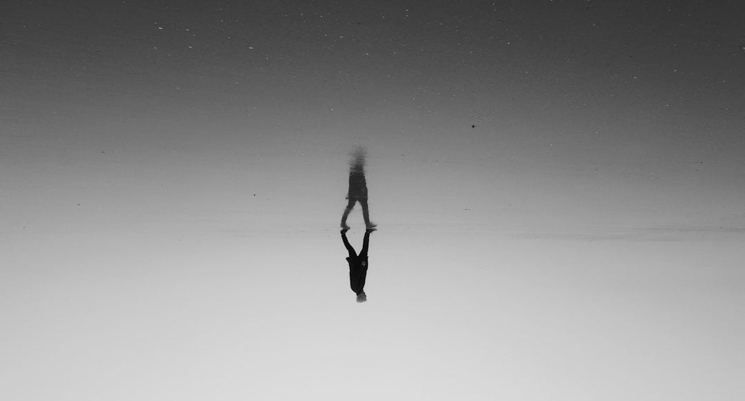 a person standing in the middle of a body of water a person standing in the middle of a body of water